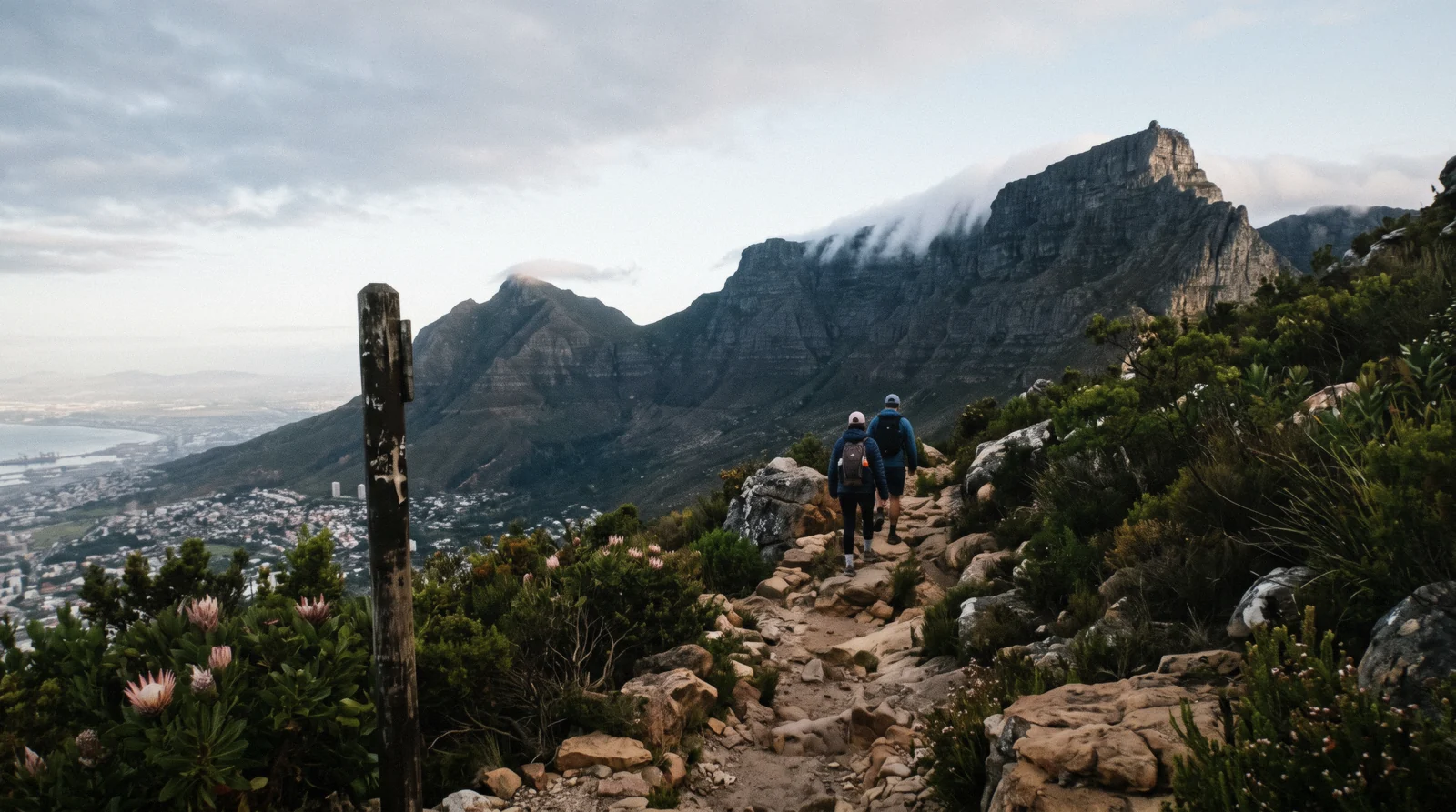 The flat summit of Table Mountain above the city bowl with a tablecloth cloud spilling over the edge, Table Mountain Cape Town