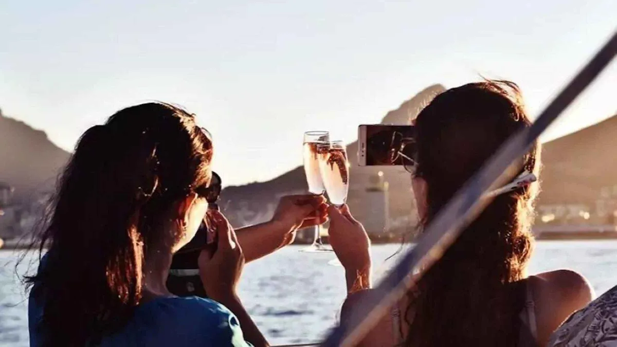 Sparkling wine poured on deck during a sunset cruise on Table Bay, Cape Town