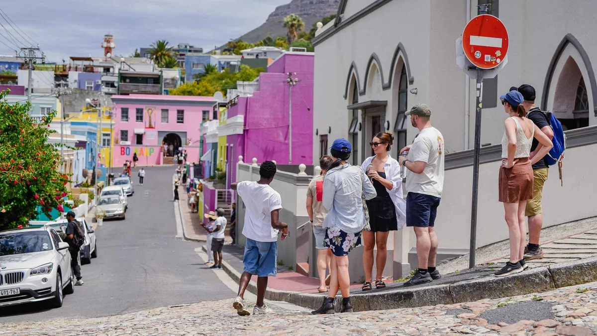Guide showing street art to a walking group on an art and history tour of Cape Town