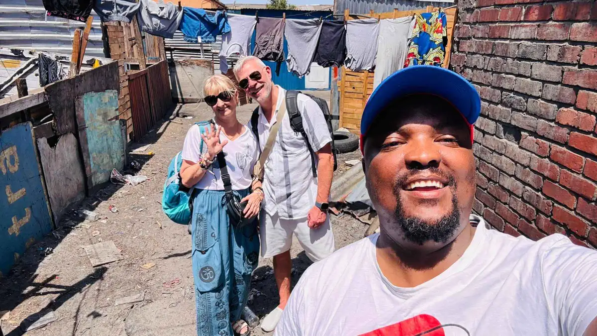Resident guide leading visitors down a street in Langa on a township walking tour, Cape Town