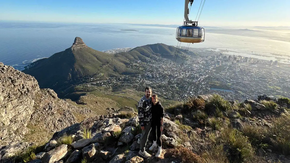 Hiking guide pointing out fynbos on a Table Mountain trail hike, Cape Town